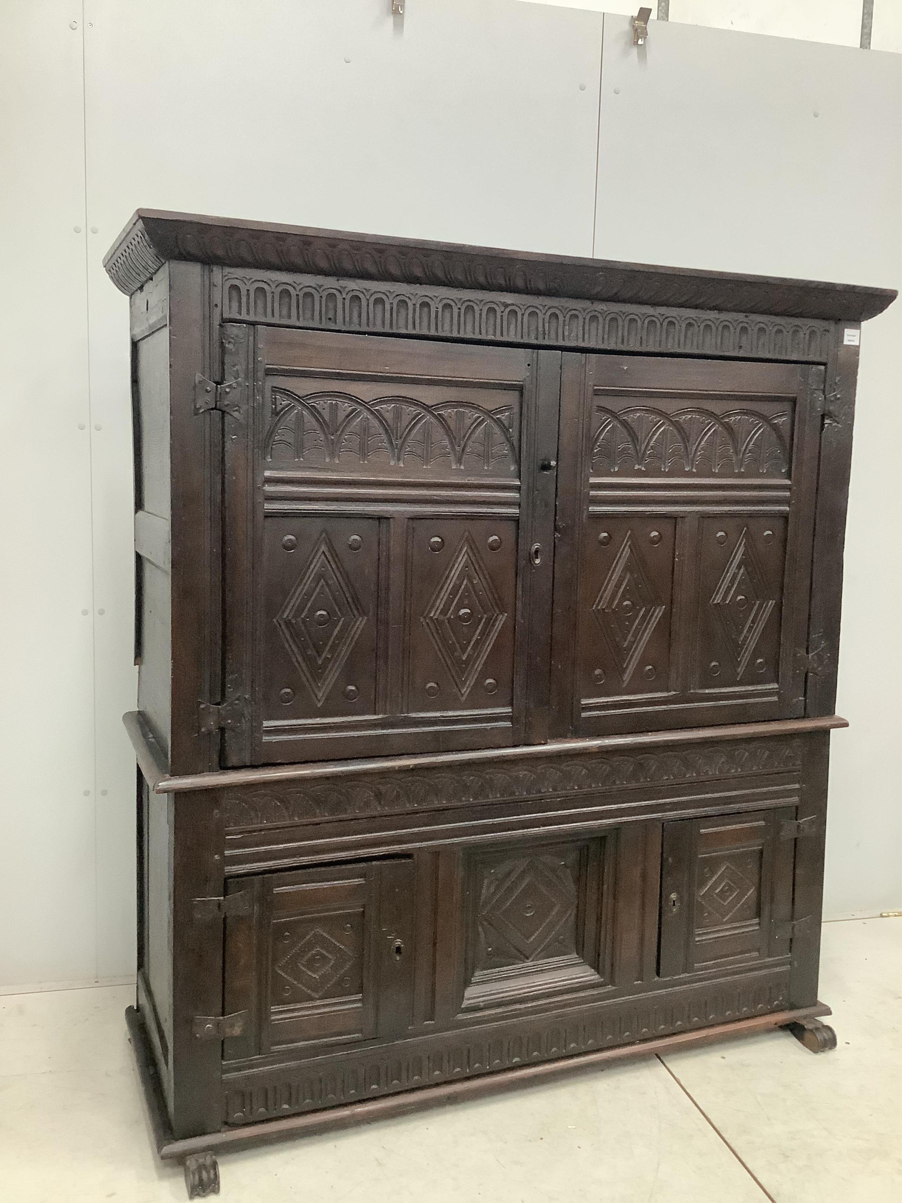 A late 17th century Continental carved oak two section cupboard, width 166cm, depth 57cm, height 167cm. Condition - fair